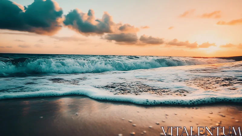 Sunset waves rolling onto wet sandy beach shoreline.