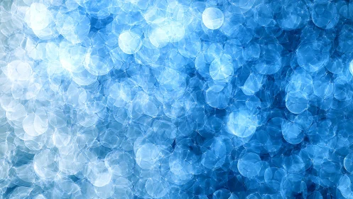 Blue bokeh light abstraction with layered circular glow.