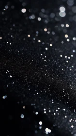 Stellar bokeh particles drift through deep black void.
