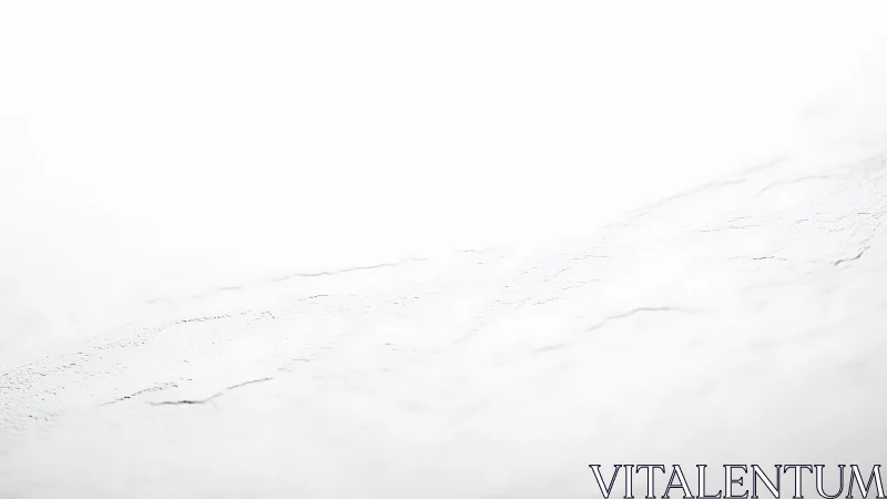 Minimal white textured surface dissolves into bright negative space