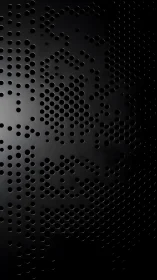 Perforated shadows whisper across a curved black surface