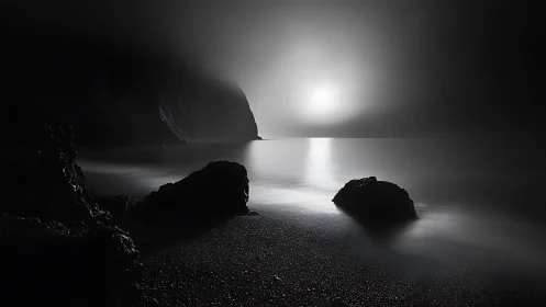 Long-exposure littoral nocturne with fog-diffused backlight.