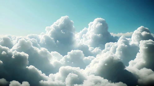 Towering cumulus clouds glow under clear cyan sky.