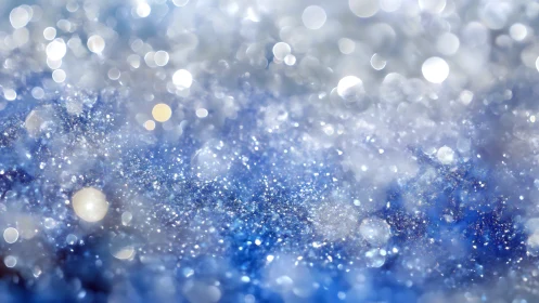 Defocused macro bokeh field of icy particulate reflections.