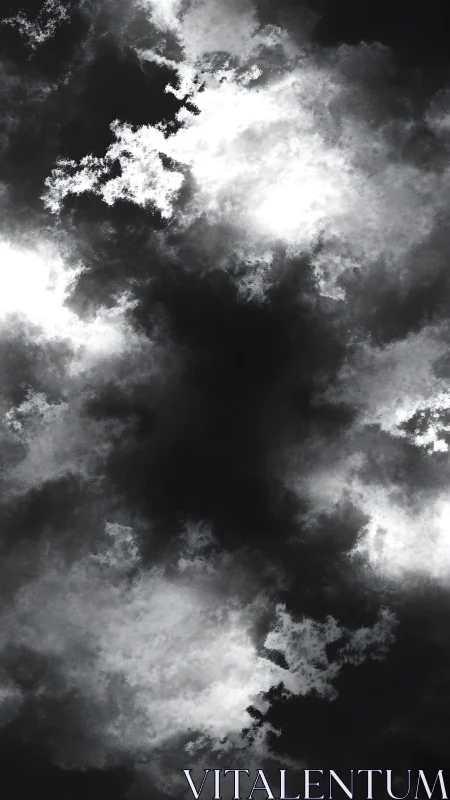 Storm-torn monochrome clouds circling a shadowed void skyward.