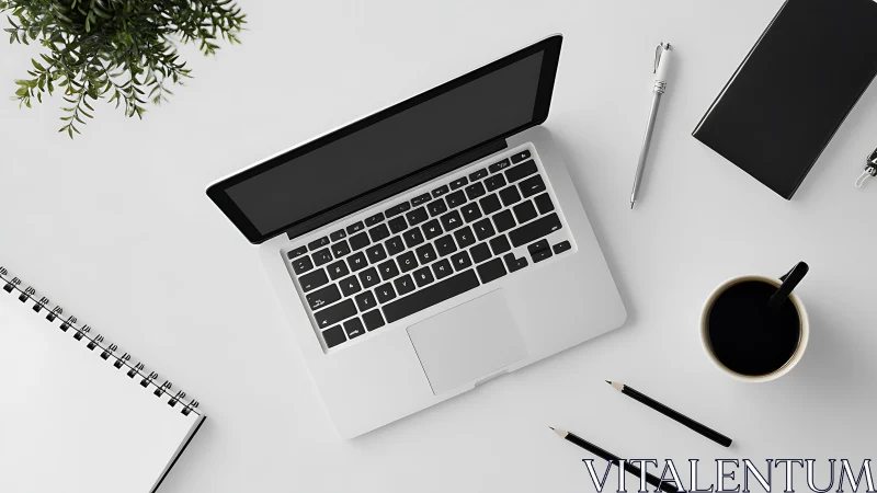 Open laptop anchors minimalist white creative workspace