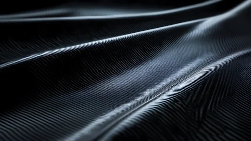 Closeup of glossy black carbon fiber textile surface.