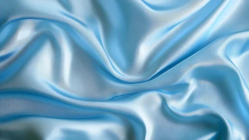 Shimmering light blue satin folds in soft fluid waves.