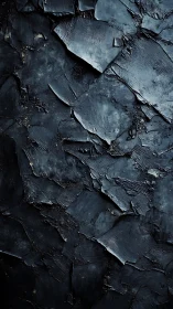 Textured black impasto surface with layered matte shards.