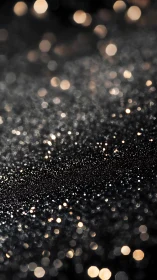 Defocused golden bokeh lights on dark abstract surface.