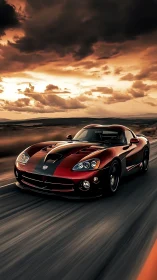 Red sports coupe driving under dramatic sunset sky.