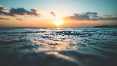 Low-angle ocean horizon at vivid golden hour sunset.