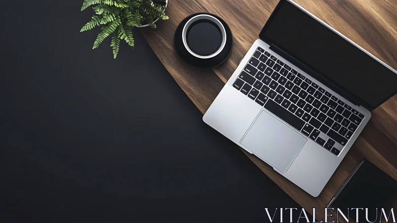 Laptop on wooden desk with coffee cup and plant overhead.