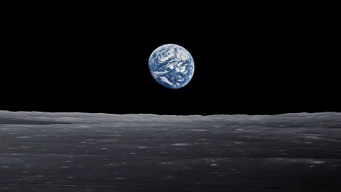 Gentle Earthrise above the moon’s quiet grey horizon.