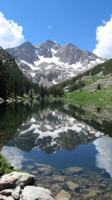 Mountain peaks reflect sharply in calm alpine lake water