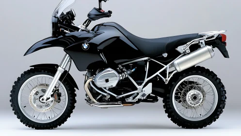 Black BMW adventure motorcycle on neutral studio background.