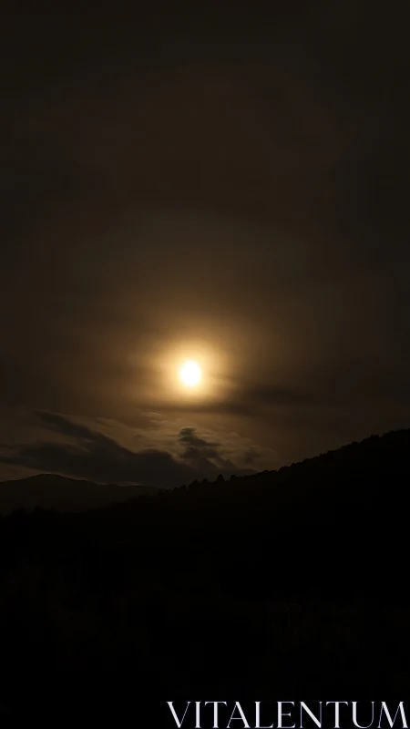 Moonlit haze settles softly above dark rolling hills.