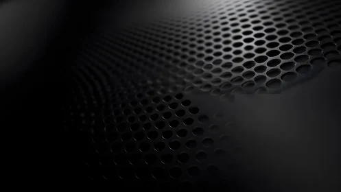 Close-up of Metallic Speaker Grill in Abstract Dark Lighting.