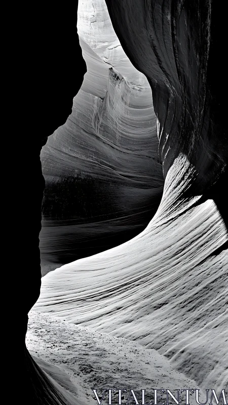 Monochrome narrow canyon with curved layered rock walls.
