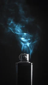 Metal lighter with blue smoke on dark isolated background.