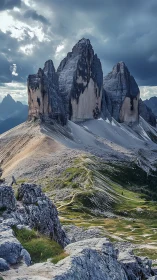 Dolomite tri-peak massif under storm-loaded stratiform sky.