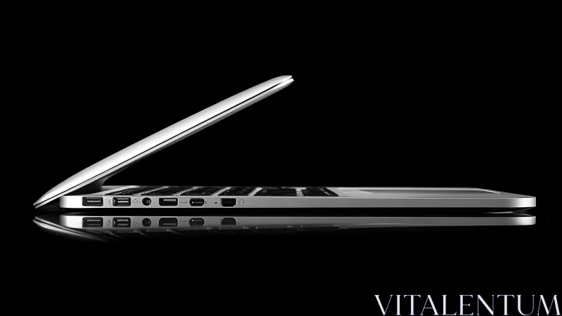 Ultrathin silver laptop in side profile under high-contrast studio lighting
