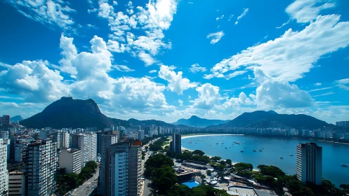Panoramic coastal cityscape captures bay, towers and cloud masses
