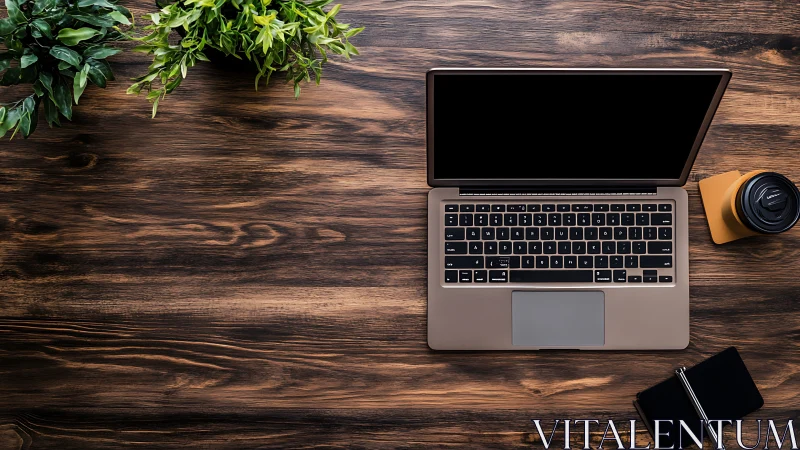 Overhead view shows minimalist laptop workstation on wood desk