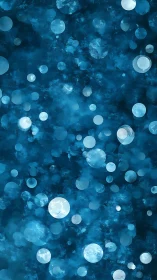 Layered cyan bokeh spheres over textured deep blue backdrop