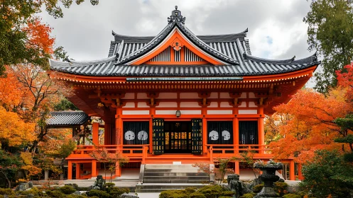 Symmetrical Japanese temple facade in autumnal landscape.