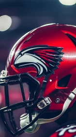Red football helmet with stylized hawk logo in profile.