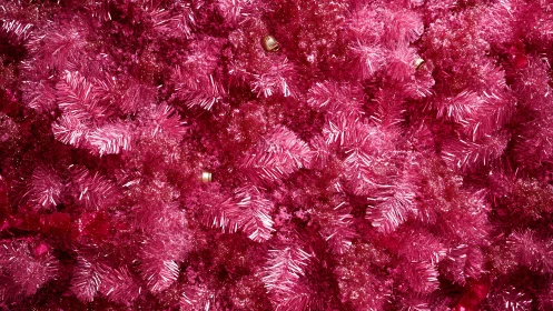 Hot pink tinsel branches create dense festive texture.