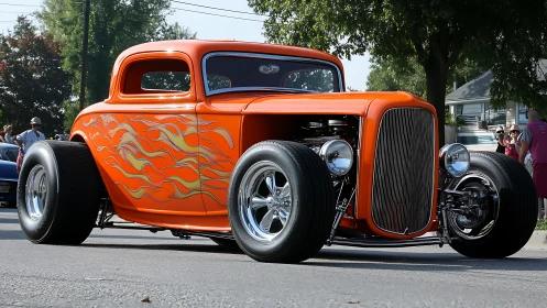 Blazing orange hot rod cruising with classic street charm.