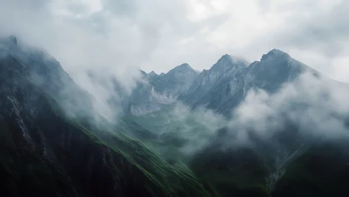 Fog-covered mountain ridge with steep rocky green slopes.