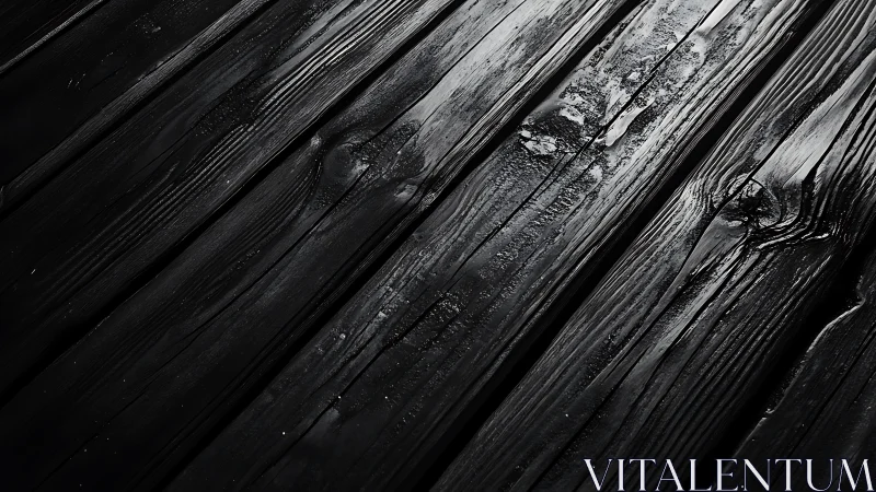 Charred black wooden planks with dramatic side lighting.