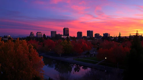 Skyline drenched in magenta dusk over autumn river park.