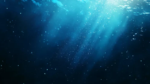 Subsurface oceanic light shafts with suspended microbubbles.