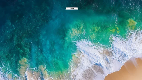Aerial ocean shoreline with waves on sandy beach scene.
