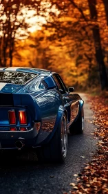 Blue classic muscle car on forest road in autumn light.