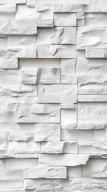 Textured white stacked stone wall with staggered modular blocks