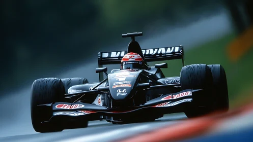 Sleek black Formula race car charges through misty circuit