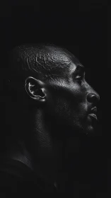 Profile portrait shows side-lit male head in deep shadow