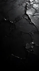 Textured black cracked surface with metallic highlights study.