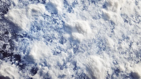 Photorealistic granular snow texture on frozen blue surface.