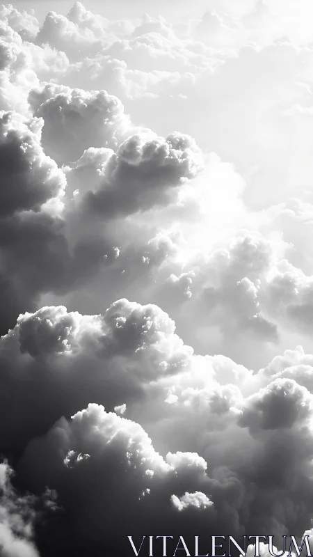 Monochrome cloudscape with layered sunlit formations.