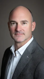 Corporate headshot with confident middle-aged businessman.