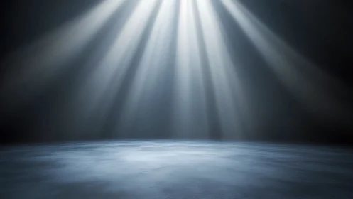 Empty stage floor under strong focused overhead lights.