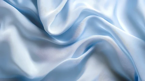 Close-up of light blue fabric folds with soft surface texture.