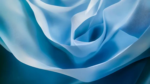 Silken blue currents swirl into a luminous abstract bloom.