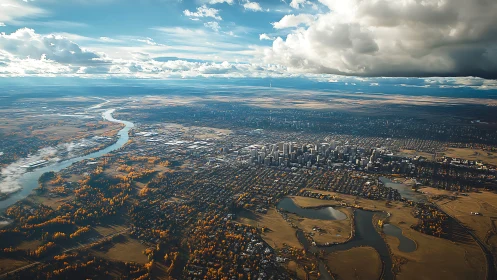 Autumn city skyline with river meanders under dramatic clouds.